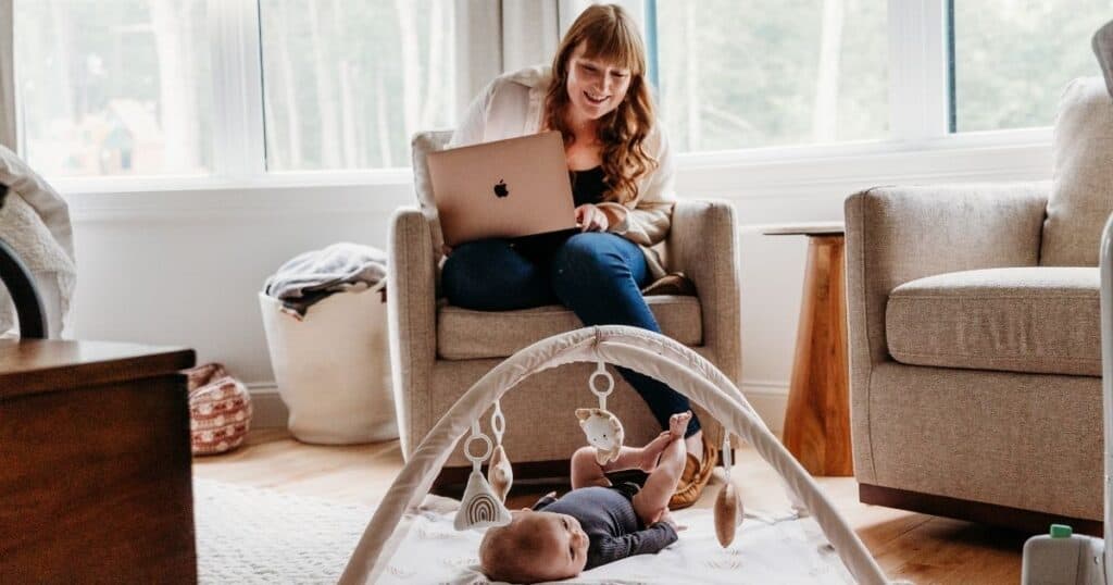 Working-mom-watching-baby Mom works while watching baby