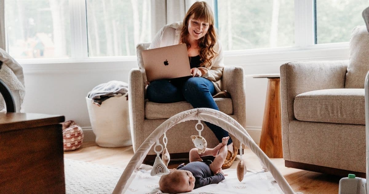 Working-mom-watching-baby Mom works while watching baby