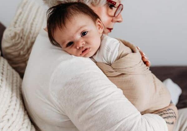 24_7 Live-In Care newborn care specialist holding young baby in swaddle
