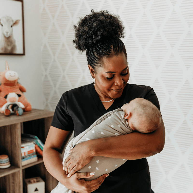 overnight newborn care doula holding baby in swaddle